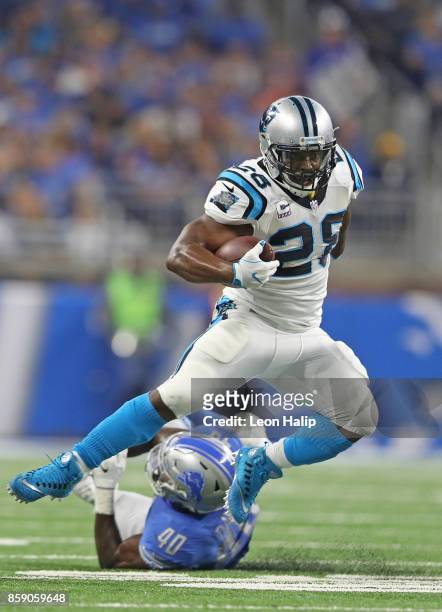 Jonathan Stewart of the Carolina Panthers runs for a first down as Jarrad Davis of the Detroit Lions attempts to make the stop during the second...