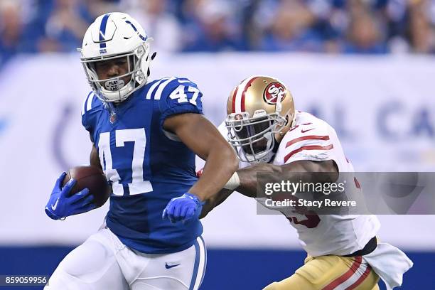 Darrell Daniels of the Indianapolis Colts is pushed out of bounds by NaVorro Bowman of the San Francisco 49ers during the second quarter of a game at...