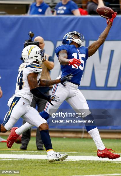 Brandon Marshall of the New York Giants leaps for a pass in front of Trevor Williams of the Los Angeles Chargers before injuring himself on the play...