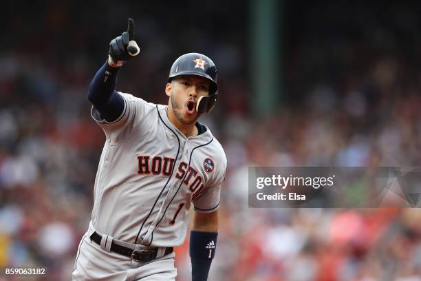 Carlos Correa of the Houston Astros celebrates as he runs the bases after hitting a two-run home run in the first inning against the Boston Red Sox...