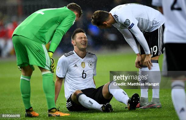 Niklas Suele of Germany sits injury on the pitch during the FIFA 2018 World Cup Qualifier between Germany and Azerbaijan at Fritz-Walter-Stadion on...