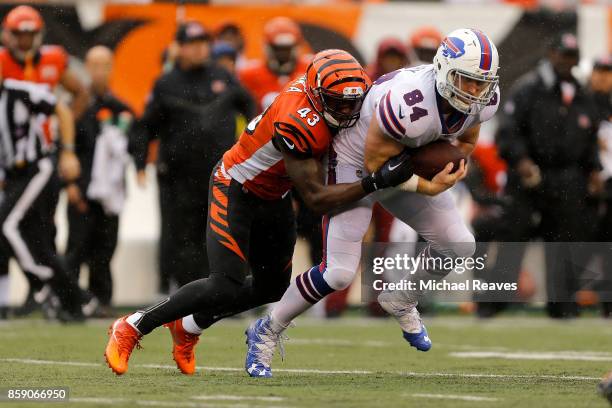 George Iloka of the Cincinnati Bengals tackles Nick O'Leary of the Buffalo Bills during the second quarter at Paul Brown Stadium on October 8, 2017...