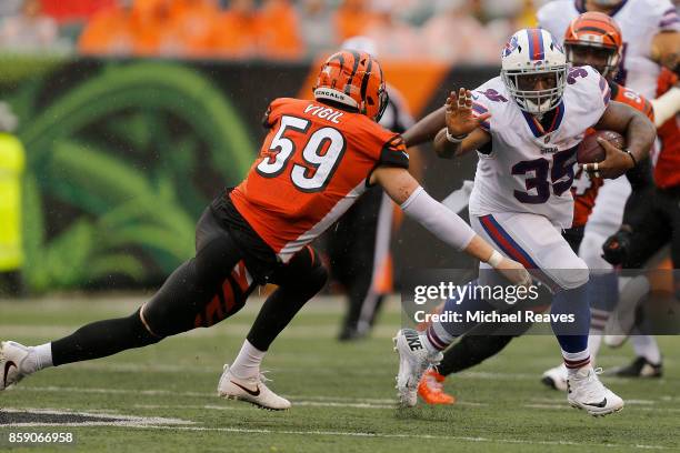 Nick Vigil of the Cincinnati Bengals attempts to tackle Mike Tolbert of the Buffalo Bills during the second quarter at Paul Brown Stadium on October...