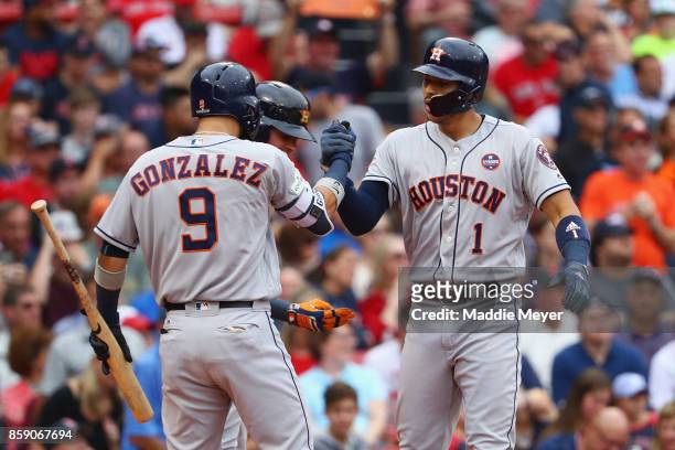 Carlos Correa of the Houston Astros celebrates with Marwin Gonzalez after hitting a two-run home run in the first inning against the Boston Red Sox...