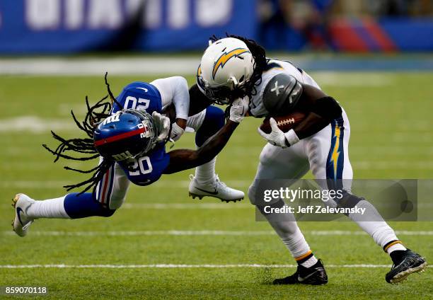 Melvin Gordon of the Los Angeles Chargers breaks free of Janoris Jenkins of the New York Giants during their game at MetLife Stadium on October 8,...