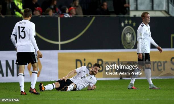 Shkodran Mustafi of Germany lies injured on the pitch during the FIFA 2018 World Cup Qualifier between Germany and Azerbaijan at Fritz-Walter-Stadion...