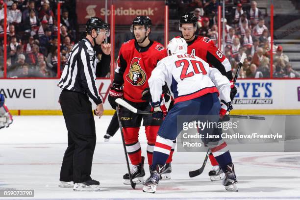 Derick Brassard of the Ottawa Senators looks at linesman Devin Berg as he takes a faceoff against Lars Eller of the Washington Capitals at Canadian...