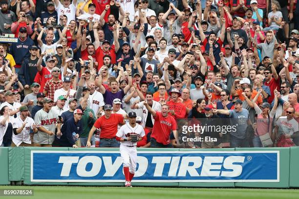 Fans cheer after Mookie Betts of the Boston Red Sox caught a ball hit by Josh Reddick of the Houston Astros in the second inning during game three of...