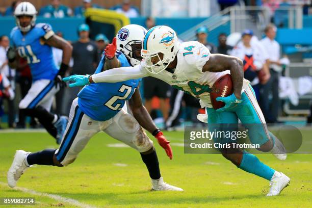Jarvis Landry of the Miami Dolphins tries to avoid the tackle of Da'Norris Searcy of the Tennessee Titans in the fourth quarter on October 8, 2017 at...