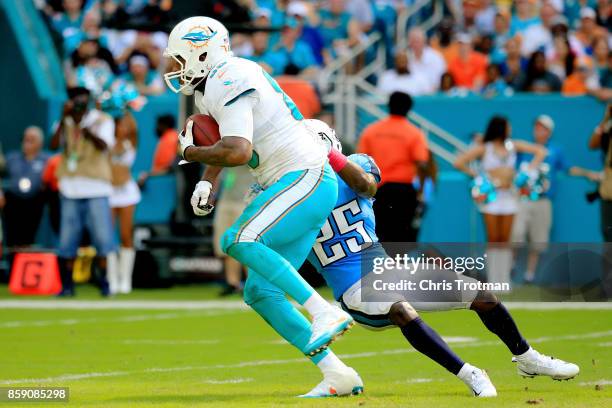 Julius Thomas of the Miami Dolphins tries to avoid the tackle of Adoree' Jackson of the Tennessee Titans in the fourth quarter on October 8, 2017 at...