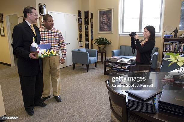 Vote staffers Eugene Kinlow, checked shirt, and Abby Levine, taking picture, show off their "Give DC Peeps the Vote" diorama to D.C. Council Chairman...