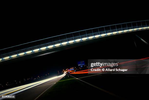 light trails on highway - heerhugowaard stock pictures, royalty-free photos & images