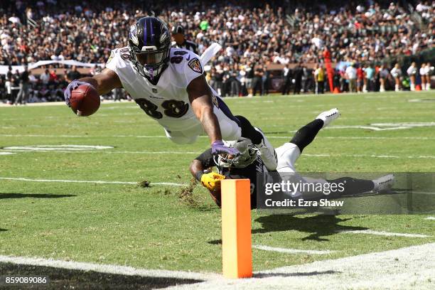Vince Mayle of the Baltimore Ravens dives for a touchdown against the Oakland Raiders during their NFL game at Oakland-Alameda County Coliseum on...