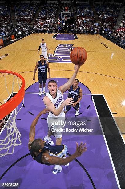 Spencer Hawes of the Sacramento Kings shoots over Quinton Ross of the Memphis Grizzlies during the game at Arco Arena on March 27, 2009 in...