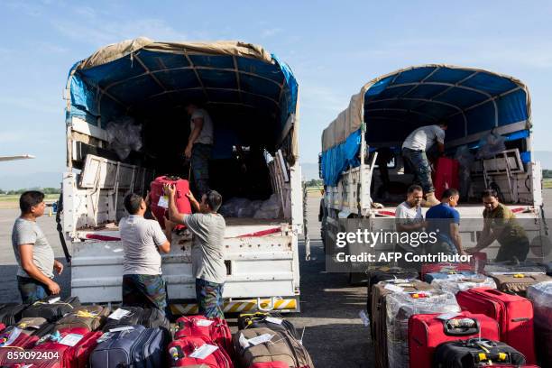 Bangladeshi peacekeepers of the United Nations Stabilization Mission in Haiti prepare to leave Haiti at Toussaint Louverture International Airport in...