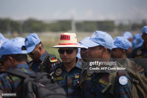 Bangladeshi peacekeepers of the United Nations Stabilization Mission in Haiti prepare to leave Haiti at Toussaint Louverture International Airport in...