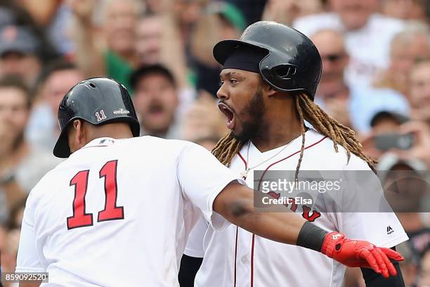 Rafael Devers celebrates with Hanley Ramirez of the Boston Red Sox after hitting a two-run home run in the third inning against the Houston Astros...