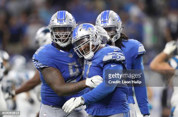 Armonty Bryant and A'Shawn Robinson of the Detroit Lions celebrate a fourth down stop against the Carolina Panthers at Ford Field on October 8, 2017...