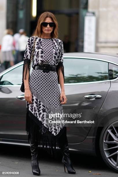 Guest wears a black and white dress with printed features, outside Andrew GN, during Paris Fashion Week Womenswear Spring/Summer 2018, on September...