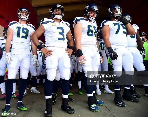 Tanner McEvoy, Russell Wilson, Justin Britt and Oday Aboushi of the Seattle Seahawks wait to get on the field before the game against the Los Angeles...