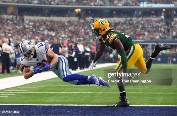 Cole Beasley of the Dallas Cowboys dives into the end zone ahead of Davon House of the Green Bay Packers in the first quarter of a football game at...