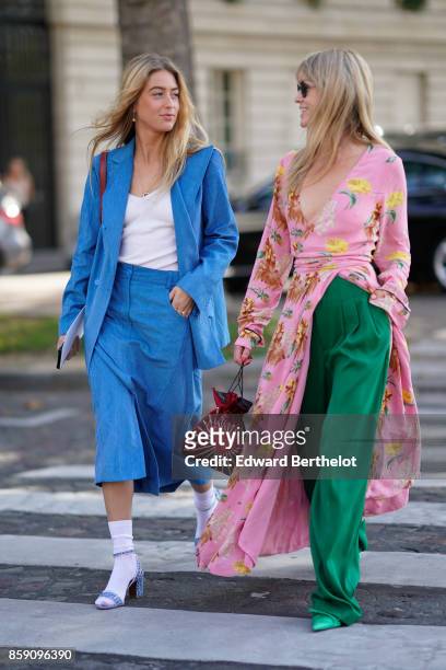 Emili Sindlev wears a blue blazer jacket, blue cropped suit pants, white socks, purple heels ; Jeanette Madsen wears a floral print pink kimono dres,...
