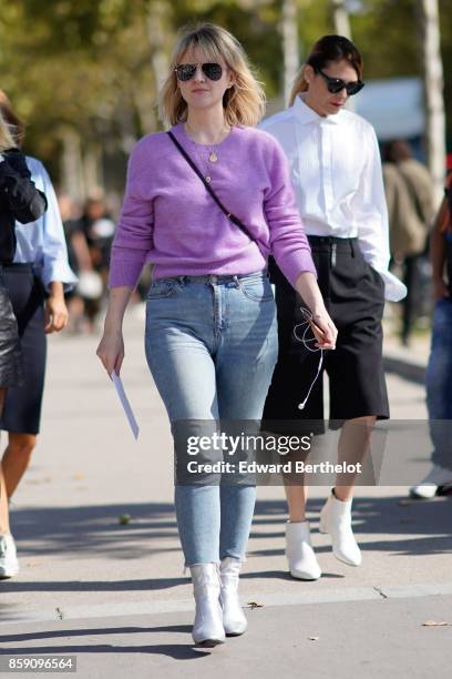 Guest wears a pink top, cropped jeans, white shoes, outside Nina Ricci, during Paris Fashion Week Womenswear Spring/Summer 2018, on September 29,...