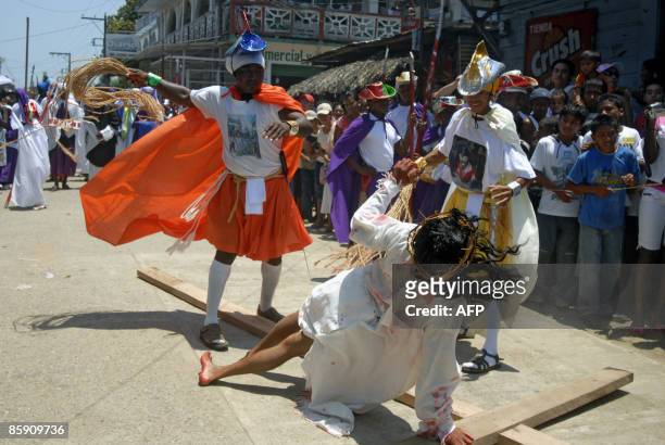 Group of actors perform the Via Crucis in the municipality of Livingston, Izabal, some 300 km north of Guatemala City, on April 10, 2009. Christians...