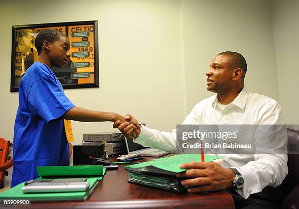 Doc Rivers coach of the Boston Celtics greets Carl from the make a wish foundation before the game against the Miami Heat on April 10, 2009 at the TD...