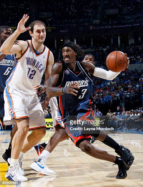 Gerald Wallace of the Charlotte Bobcats drives to the basket against Nenad Krstic of the Oklahoma City Thunder on April 10, 2009 at the Ford Center...