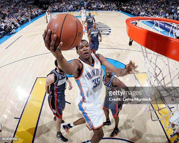 Kevin Durant of the Oklahoma City Thunder shoots a layup against Raymond Felton of the Charlotte Bobcats on April 10, 2009 at the Ford Center in...