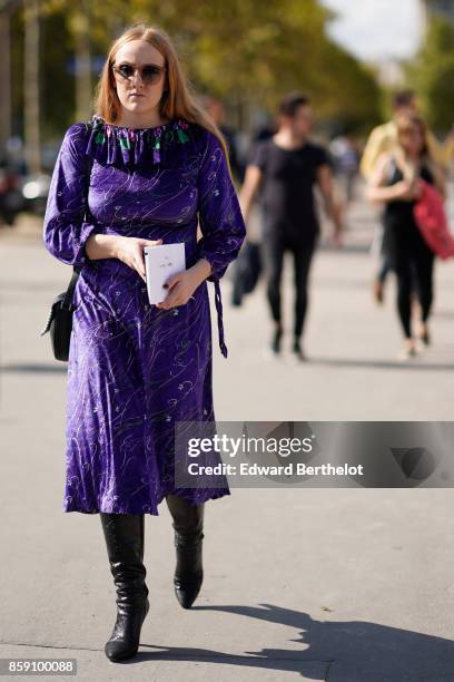 Guest wears a purple pleated ruffle dress, outside Nina Ricci, during Paris Fashion Week Womenswear Spring/Summer 2018, on September 29, 2017 in...