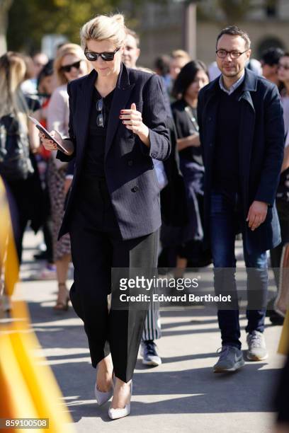 Guest wears a black blazer jacket, black pants, outside Nina Ricci, during Paris Fashion Week Womenswear Spring/Summer 2018, on September 29, 2017 in...