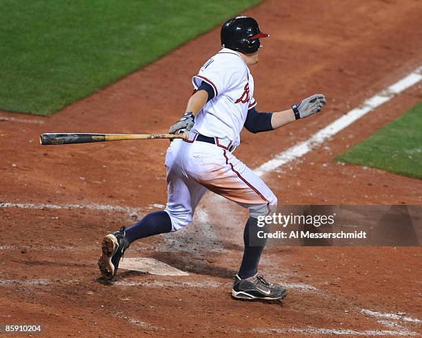 Infielder Kelly Johnson of the Atlanta Braves singles to drive in the winning run in extra innings against the Washington Nationals April 10, 2009 in...