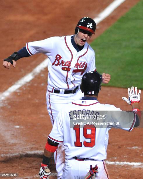 Outfielder Jordan Schafer of the Atlanta Braves scores the winning run in extra innings against the Washington Nationals April 10, 2009 in Atlanta,...