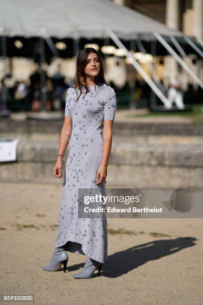 Guest wears a gray dress, outside Nina Ricci, during Paris Fashion Week Womenswear Spring/Summer 2018, on September 29, 2017 in Paris, France.