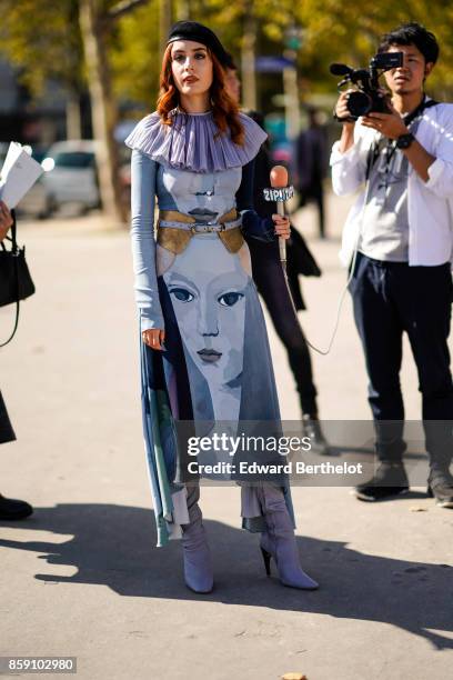 Guest wears a beret, a ruffle print dress, outside Nina Ricci, during Paris Fashion Week Womenswear Spring/Summer 2018, on September 29, 2017 in...