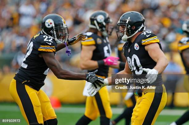 Watt of the Pittsburgh Steelers celebrates with William Gay after a defensive stop in the second half during the game against the Jacksonville...