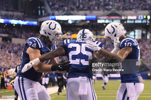 Marlon Mack of the Indianapolis Colts celebrates a touchdown with Anthony Castonzo and Donte Moncrief during the second half of a game against the...