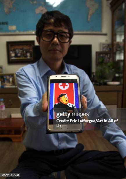 Former north Korea propaganda artist called Song Byeok showing a portrait of kim jong looking like Hitler, National Capital Area, Seoul, South Korea...