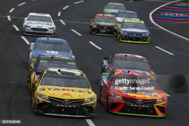 Daniel Suarez, driver of the STANLEY Toyota, and Matt Kenseth, driver of the Tide Pods Toyota, lead a pack of cars during the Monster Energy NASCAR...