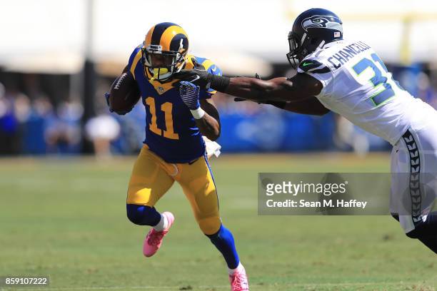 Tavon Austin of the Los Angeles Rams runs the ball down field while being guarded by Kam Chancellor of the Seattle Seahawks during the first quarter...