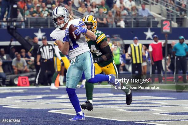 Cole Beasley of the Dallas Cowboys pulls in a touchdown pass ahead of Quinten Rollins of the Green Bay Packers in the second quarter of a football...