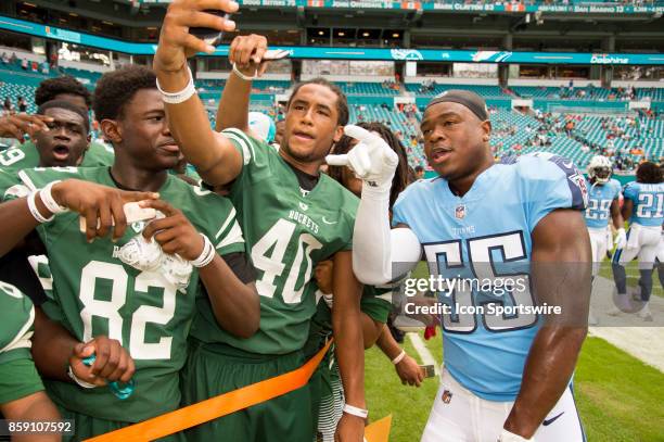 Tennessee Titans Linebacker Jayon Brown poses for a selfie with players from the Miami Central High school football team on the sidelines before an...