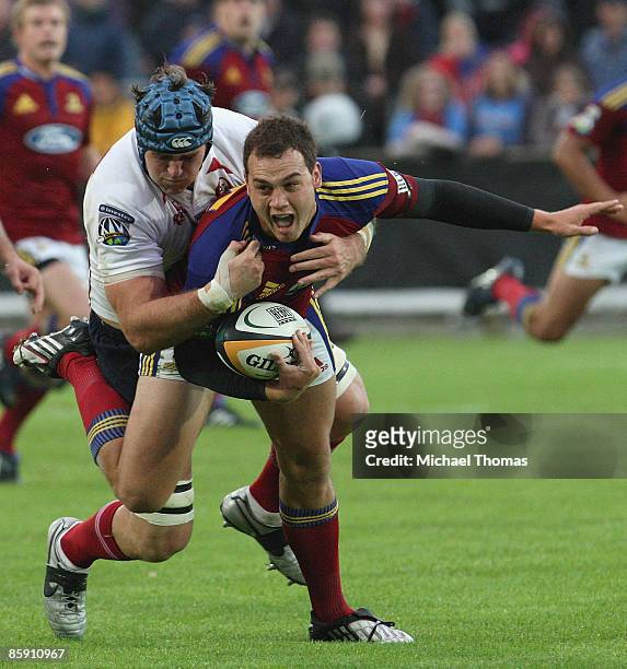 Israel Dagg of the Highlanders is tackled by James Horwill of the Reds during the round nine Super 14 match between the Highlanders and the Reds at...