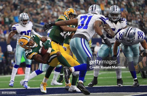 Aaron Jones of the Green Bay Packers runs for a touchdown against the Dallas Cowboys in the second quarter at AT&T Stadium on October 8, 2017 in...