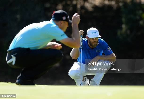 Graham DeLaet of Canada lines up a putt on the fourth hole as Brendan Steele looks on during the final round of the Safeway Open at the North Course...