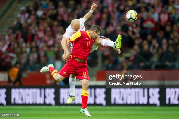 Michal Pazdan of Poland and Fatos Beciraj of Montenegro during the FIFA World Cup 2018 Qualifying Round Group E match between Poland and Montenegro...