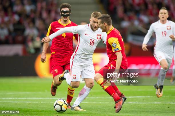 Jakub Blaszczykowski of Poland and Nemanja Mijuskovic of Montenegro during the FIFA World Cup 2018 Qualifying Round Group E match between Poland and...