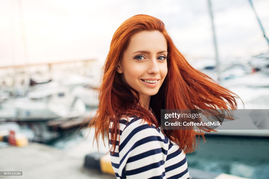 Studio shot of young beautiful woman on a pier